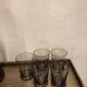 Table service set with a carafe, bottle, and 5 glass cups.