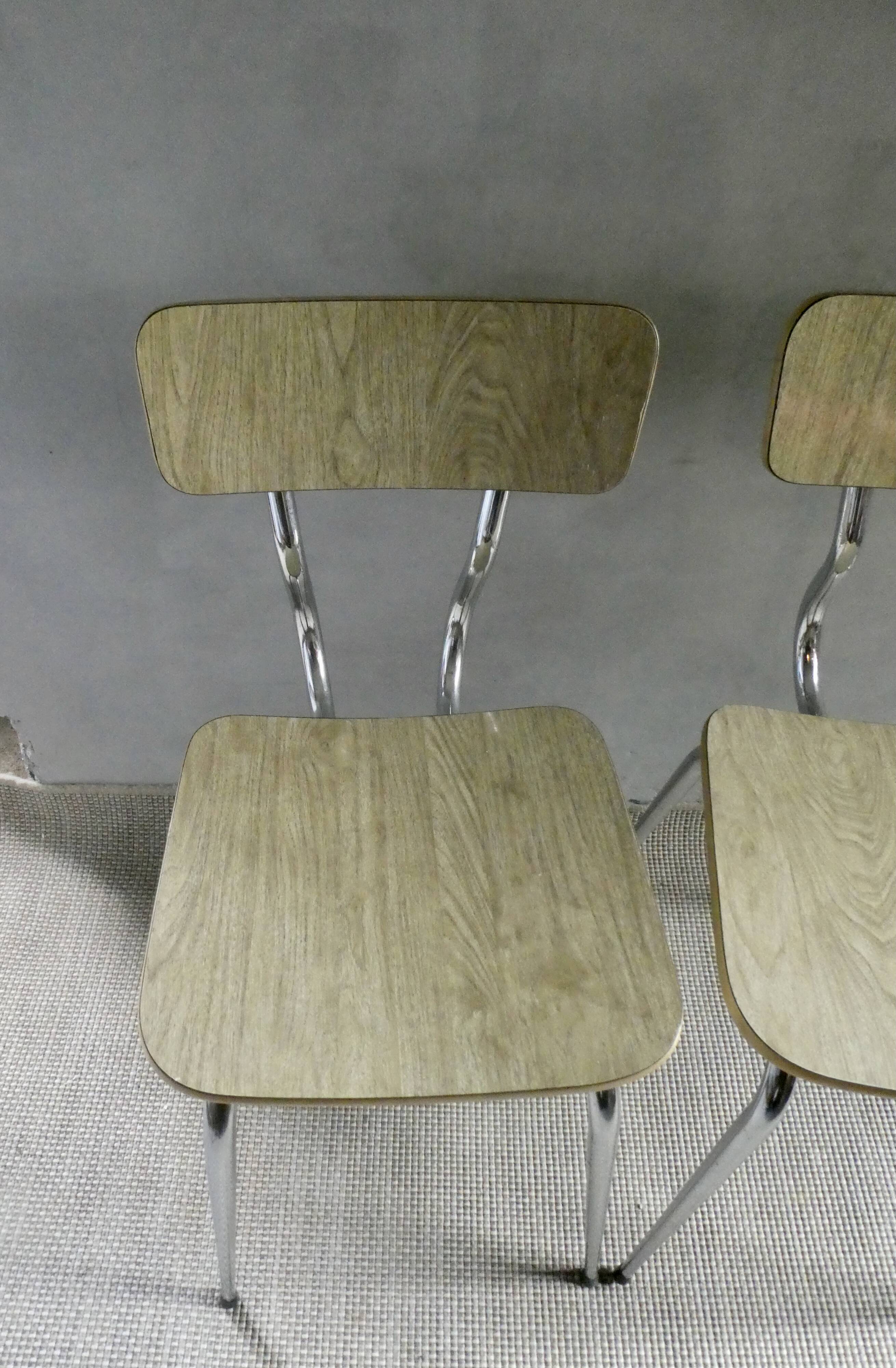Pair of chairs in "wood" formica and gold edges, 1960s