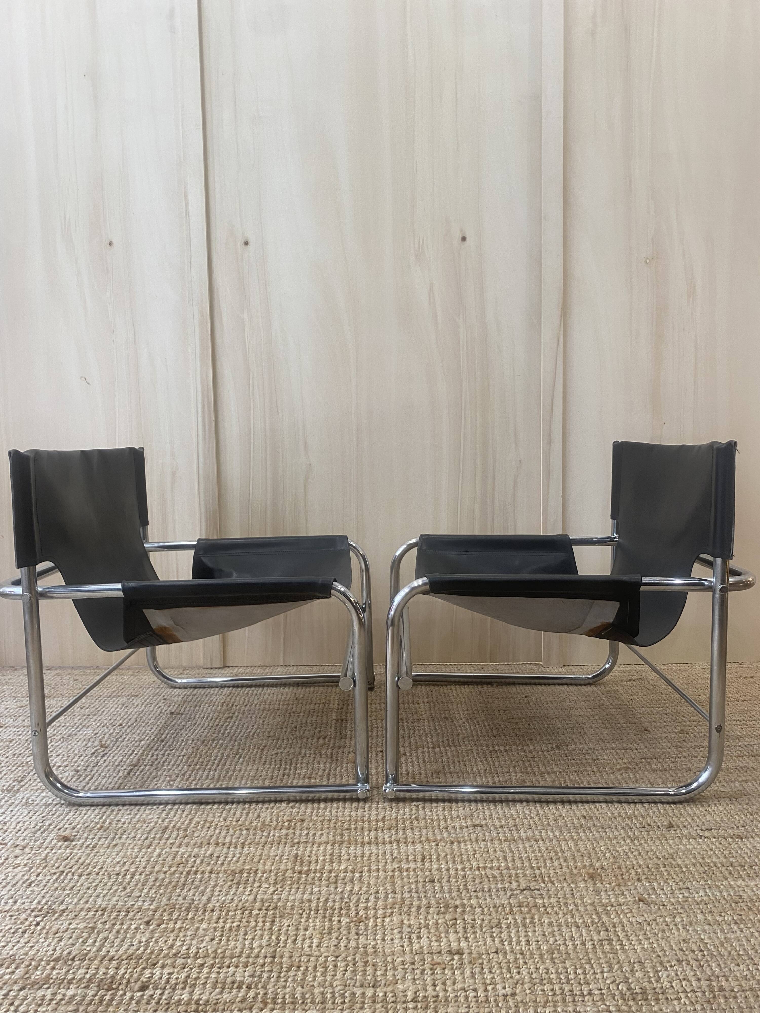 Black leather armchairs with a metal frame by Rodney Kinsman.