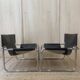 Black leather armchairs with a metal frame by Rodney Kinsman.