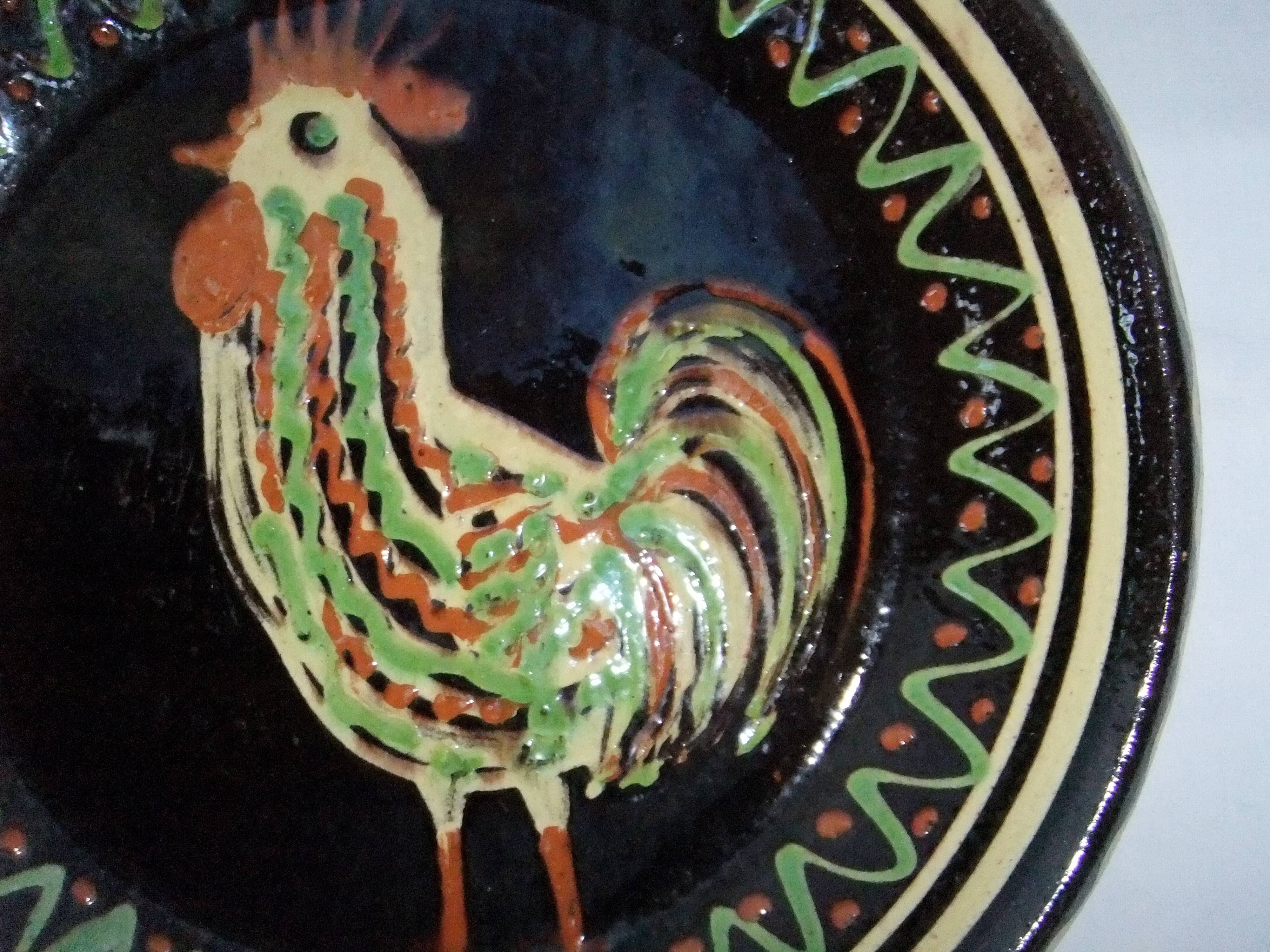 old terracotta dish decorated with rooster
