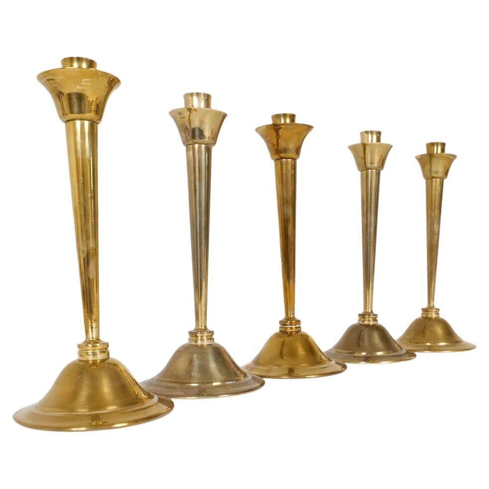Mid-century set of 5 brass candlesticks by Lars Holmström, Arvika, Sweden.