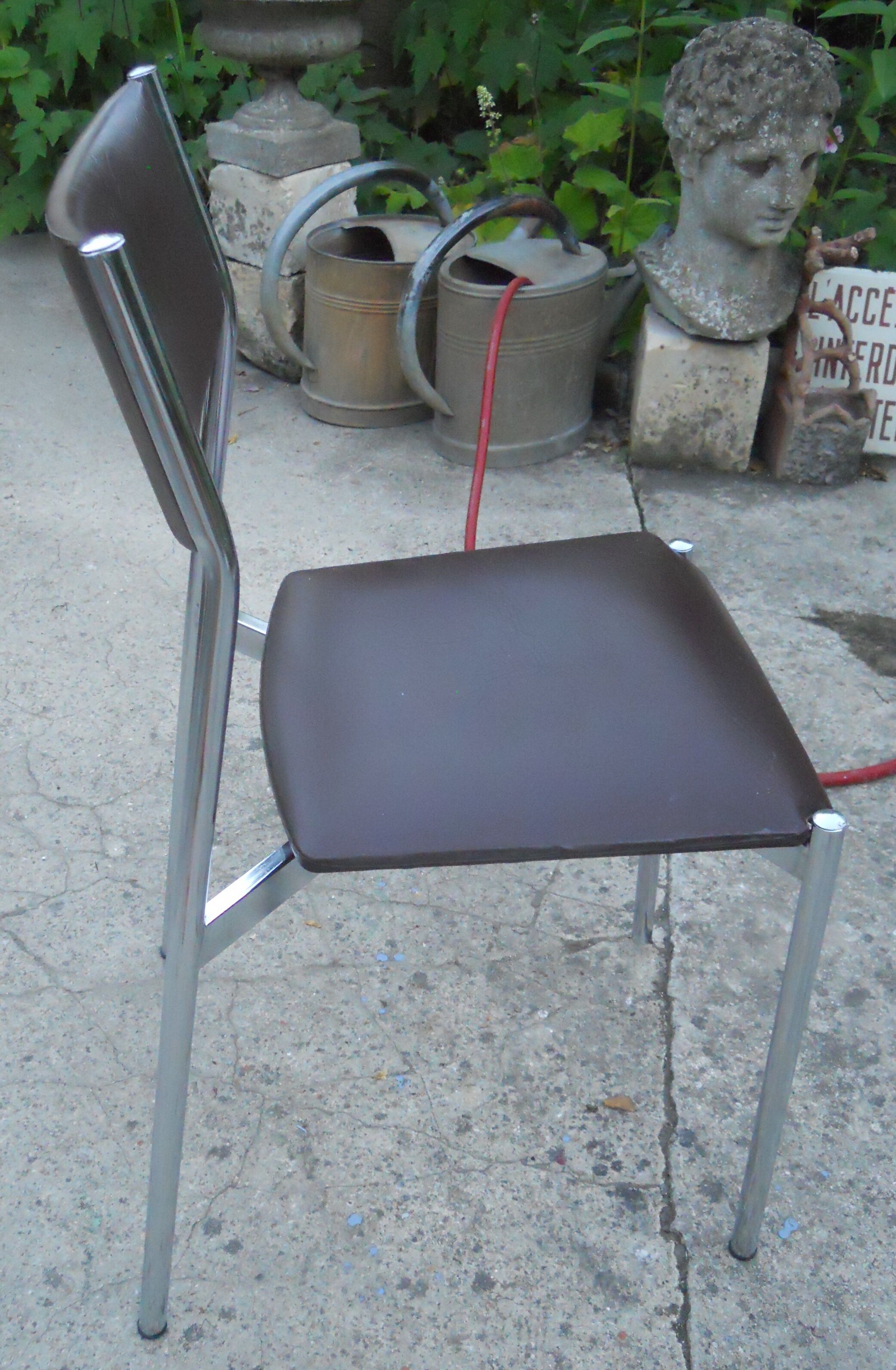 Vintage chrome metal chair and faux black leather