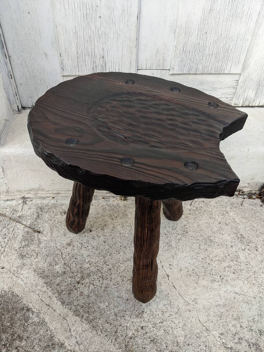 Tripod stool, horseshoe, rustic brutalist decoration.