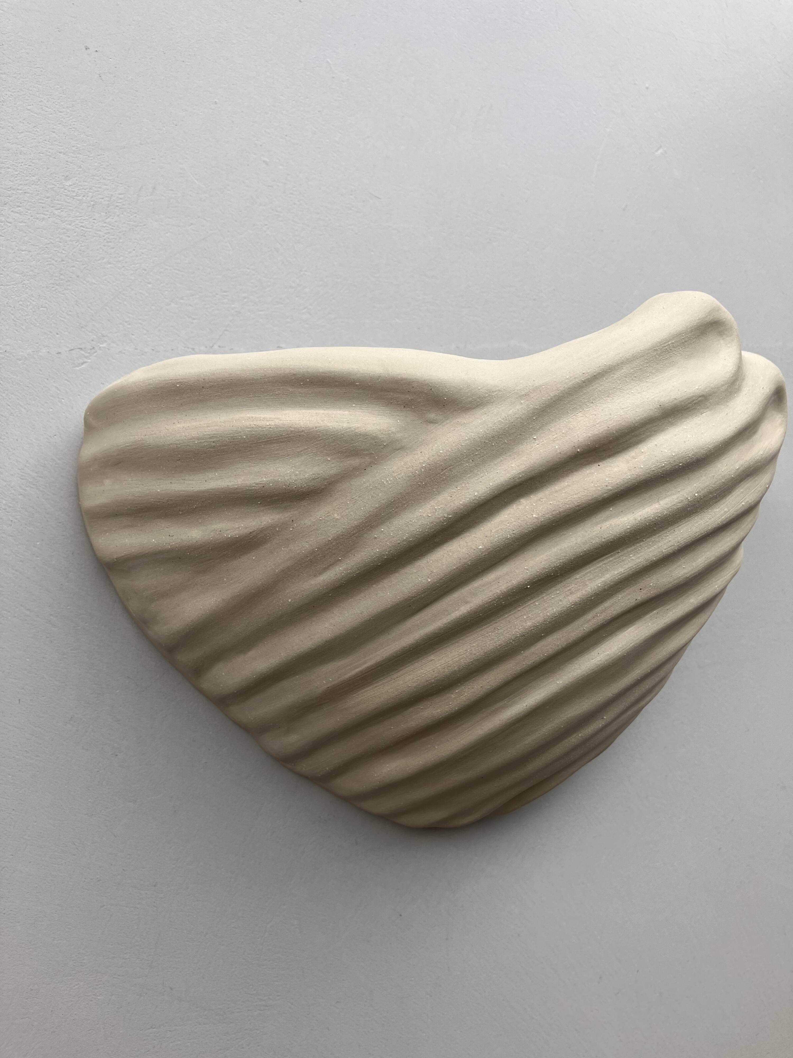 Shell-shaped ceramic applique handcrafted.