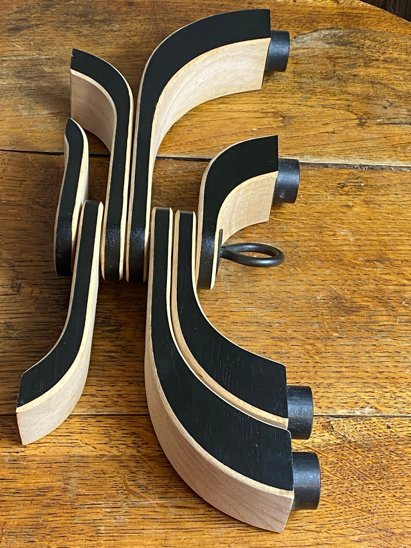 Foldable and deconstructed chandelier, minimalist Swedish design in wood.