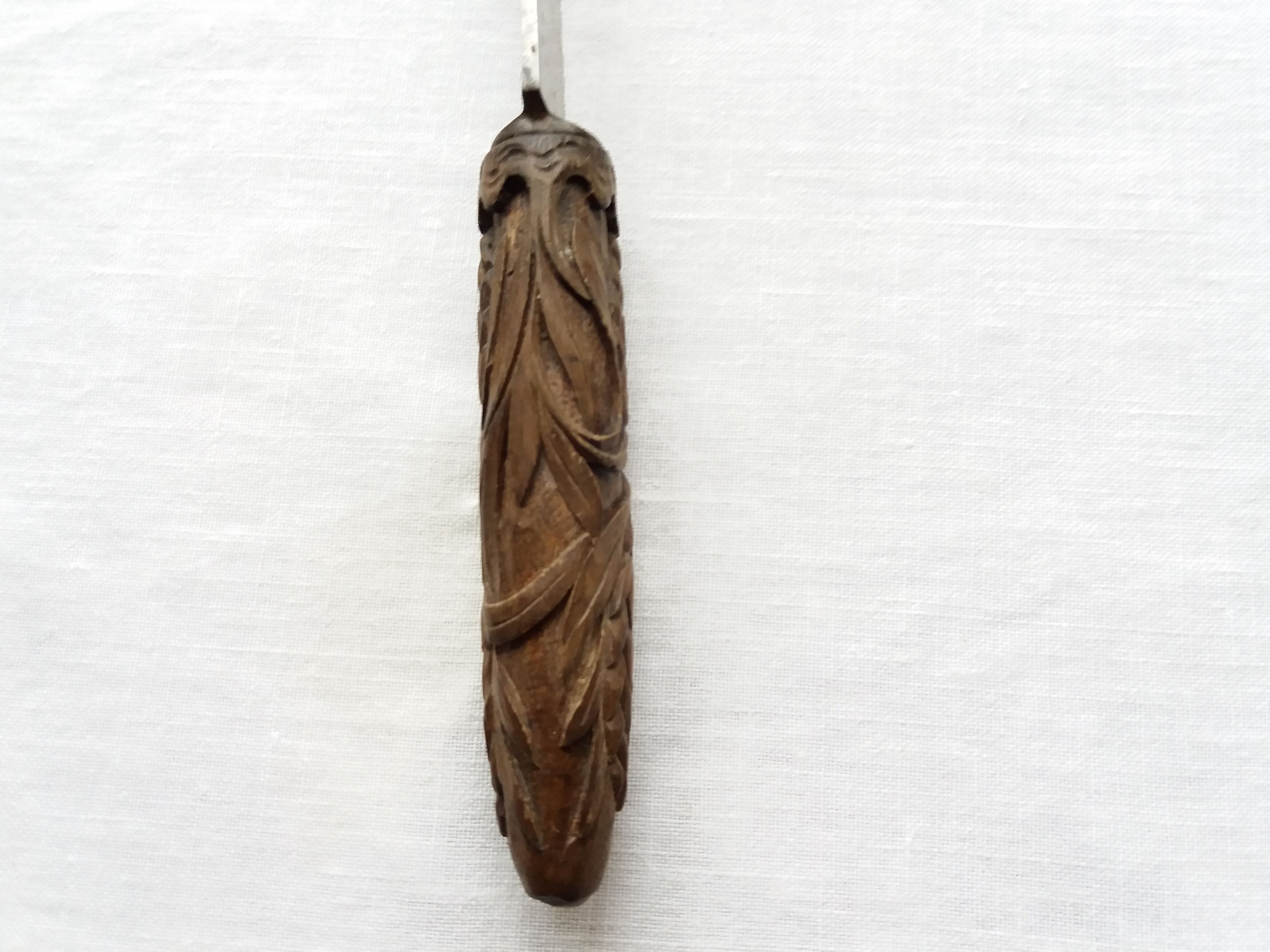 Old bread knife with a carved wooden handle