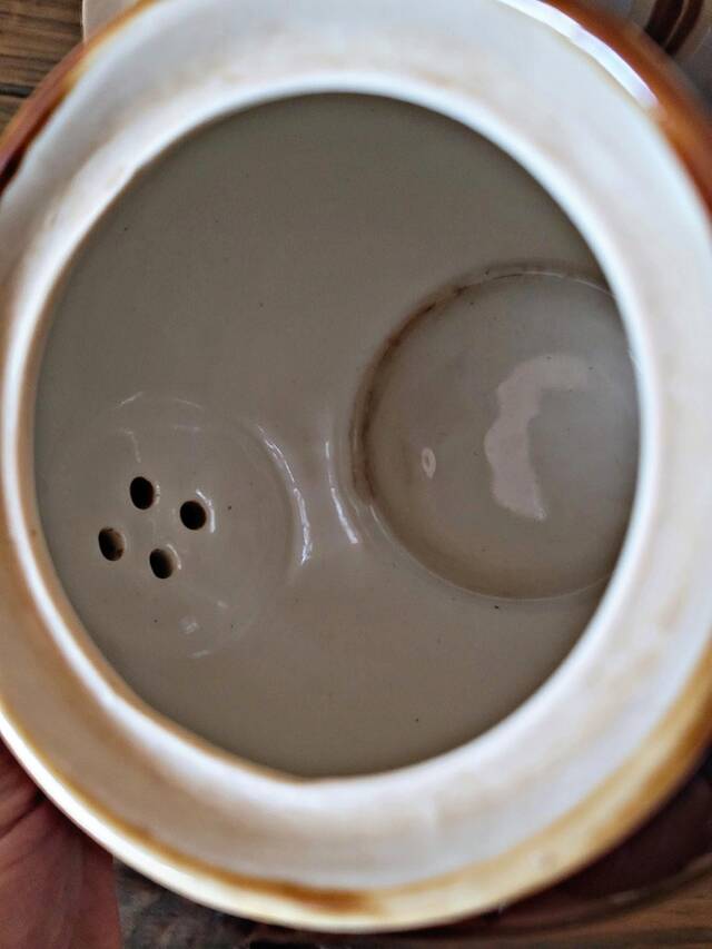 Vintage ceramic teapot (glazed earthenware) in brown colour.