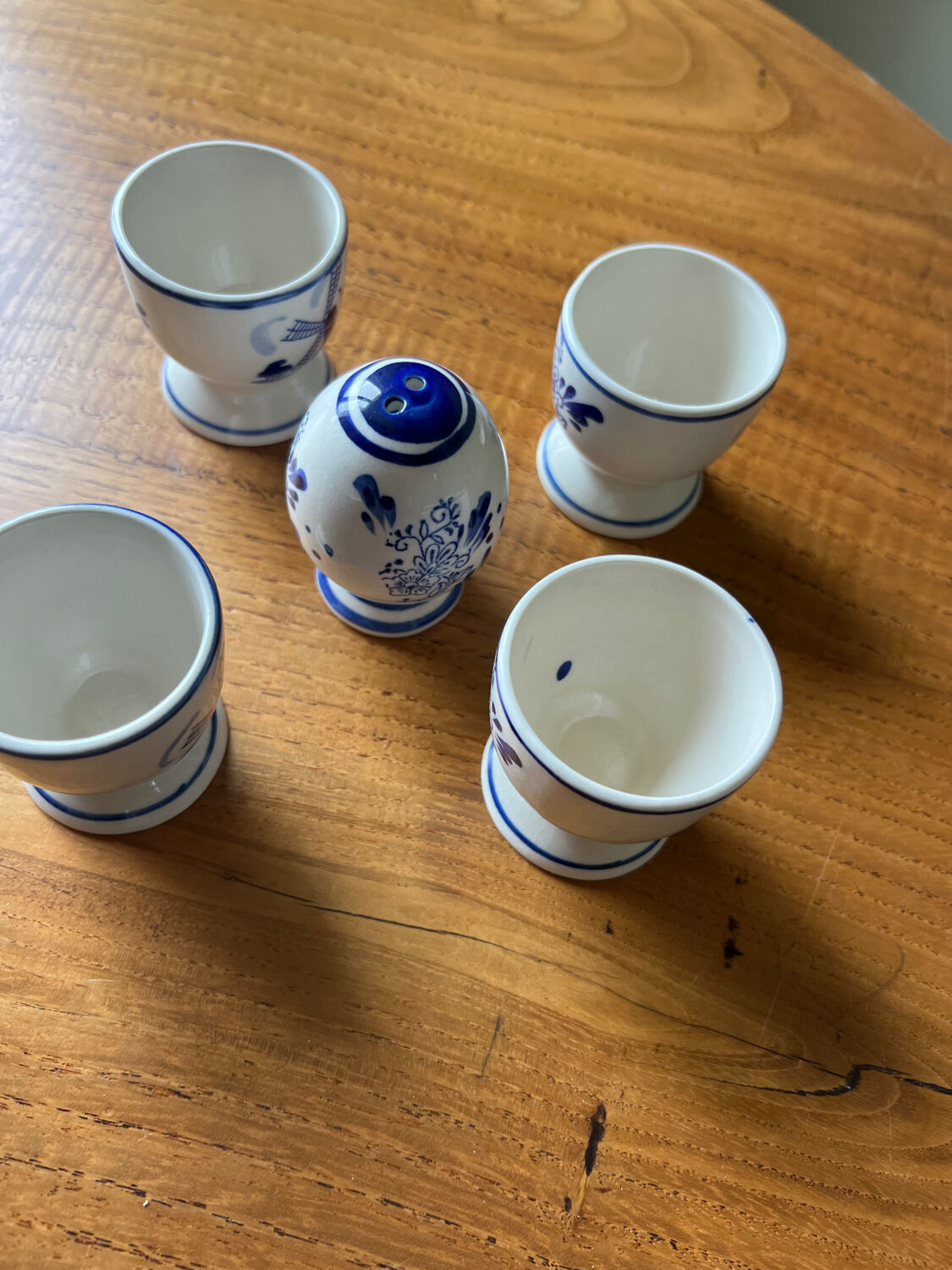 Set of 4 vintage egg cups and salt shaker in blue Delft pottery.
