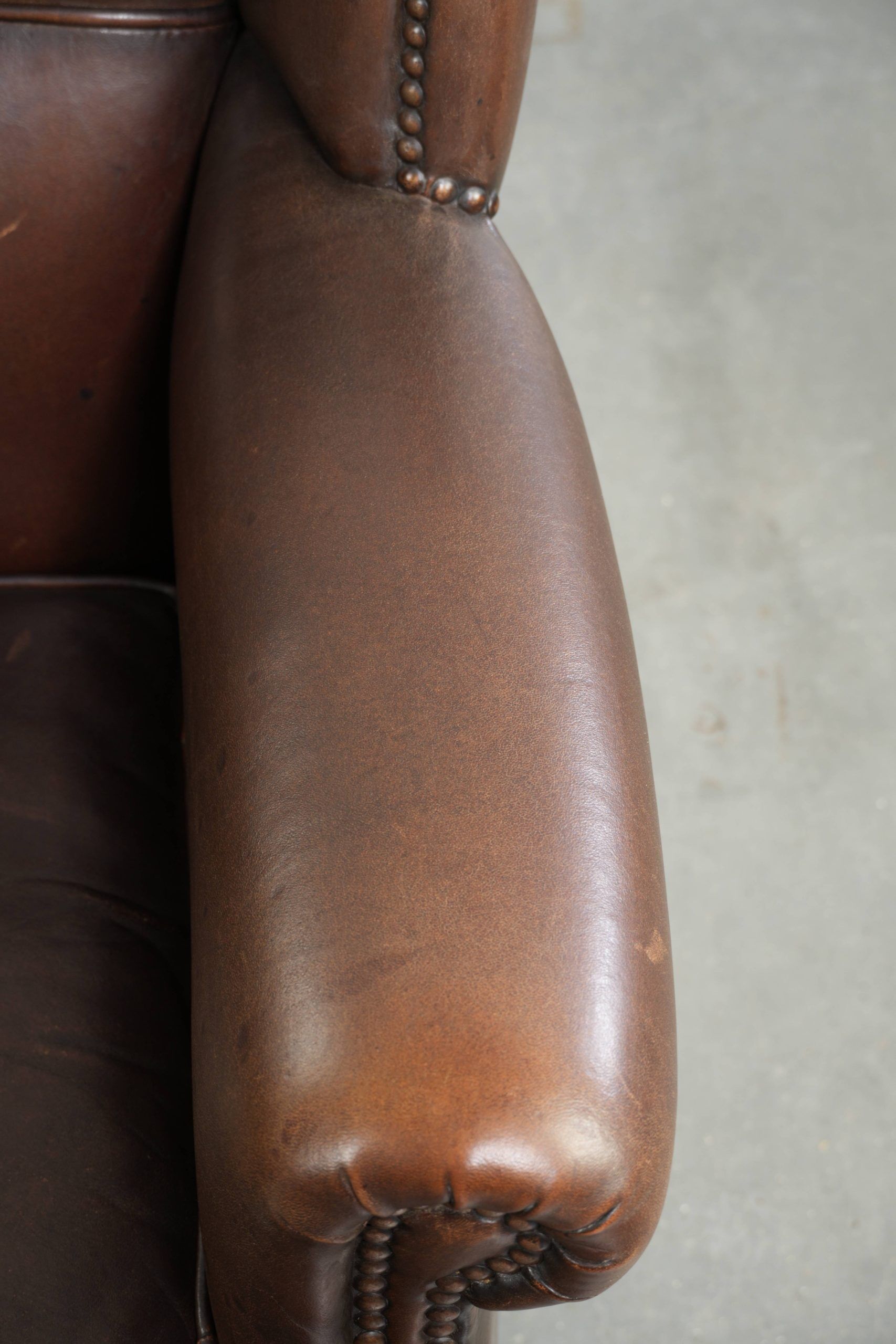 Subtle sheepskin wingback armchair with a deep cognac colour