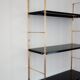 Modular string wall shelf in golden brass and black metal, 50s/60s