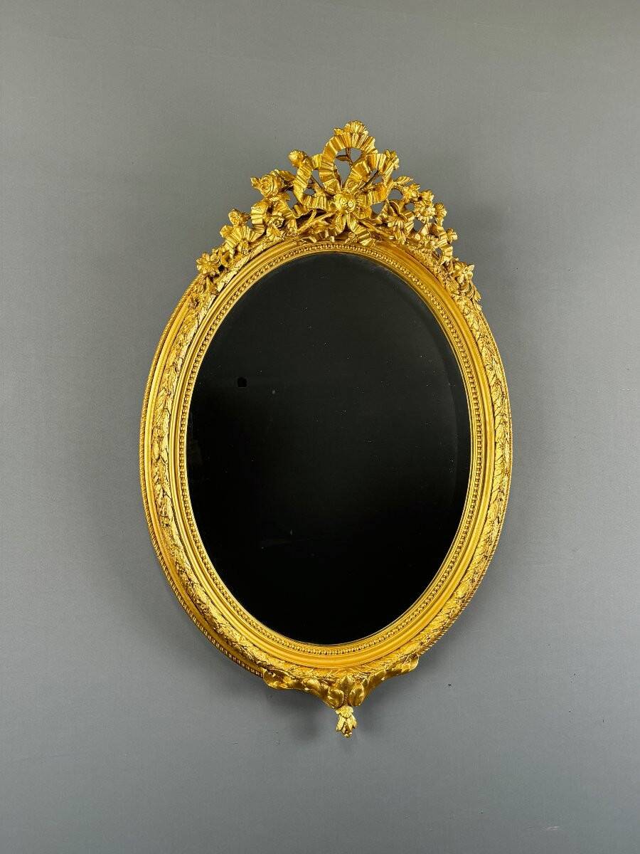 Miroir ovale doré style Louis XVI, XIXe siècle