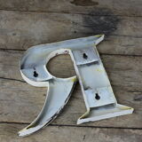 White zinc letter R