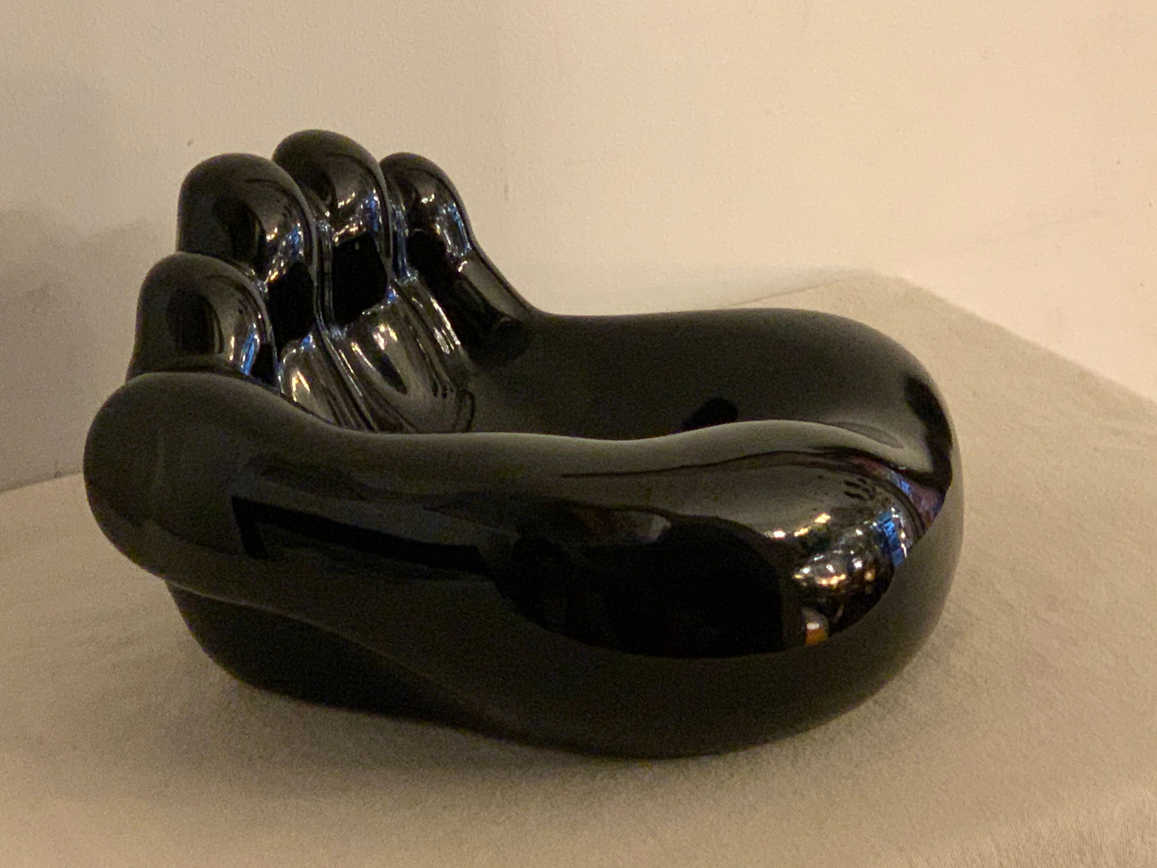 Black ceramic ashtray left hand