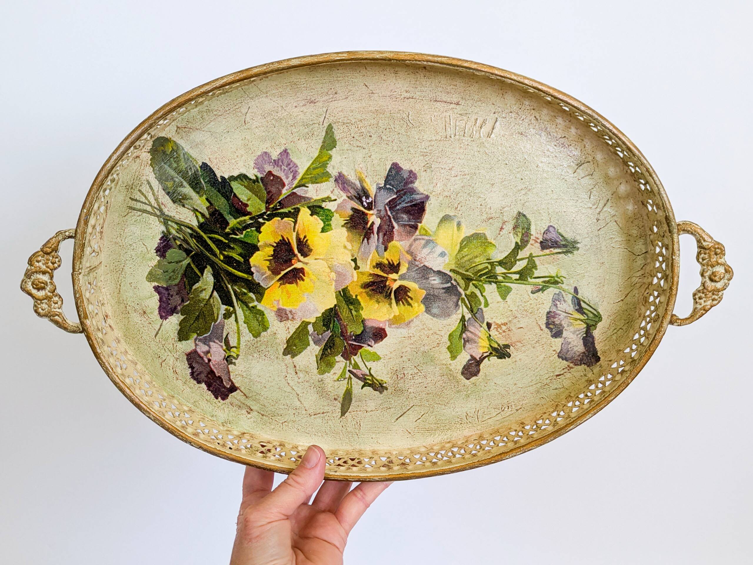 Oval metal decorative vintage tray with floral pattern.