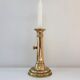 Old brass candlestick with push button.