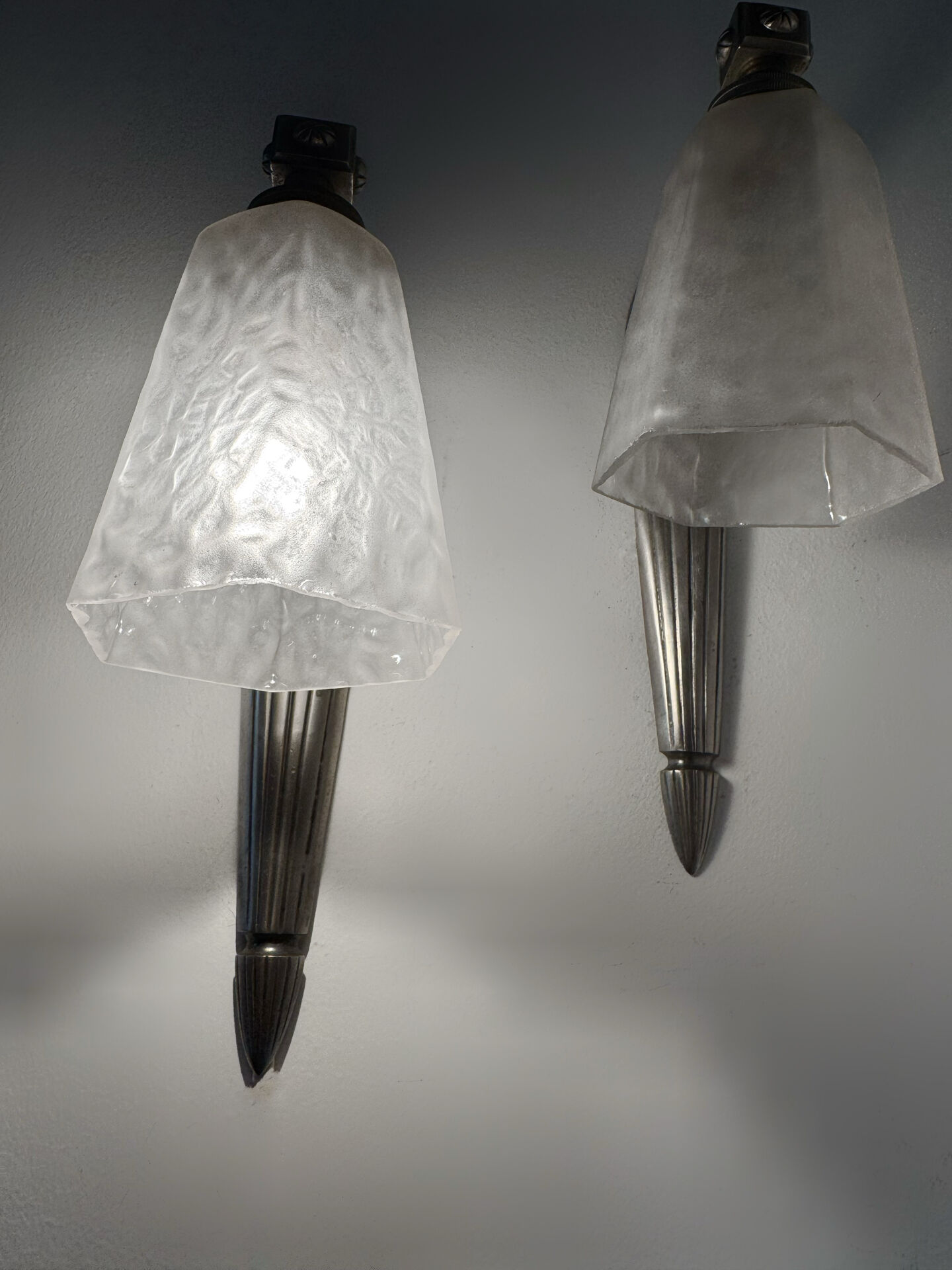 Silver Art Deco wall lights with frosted glass.