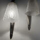 Silver Art Deco wall lights with frosted glass.