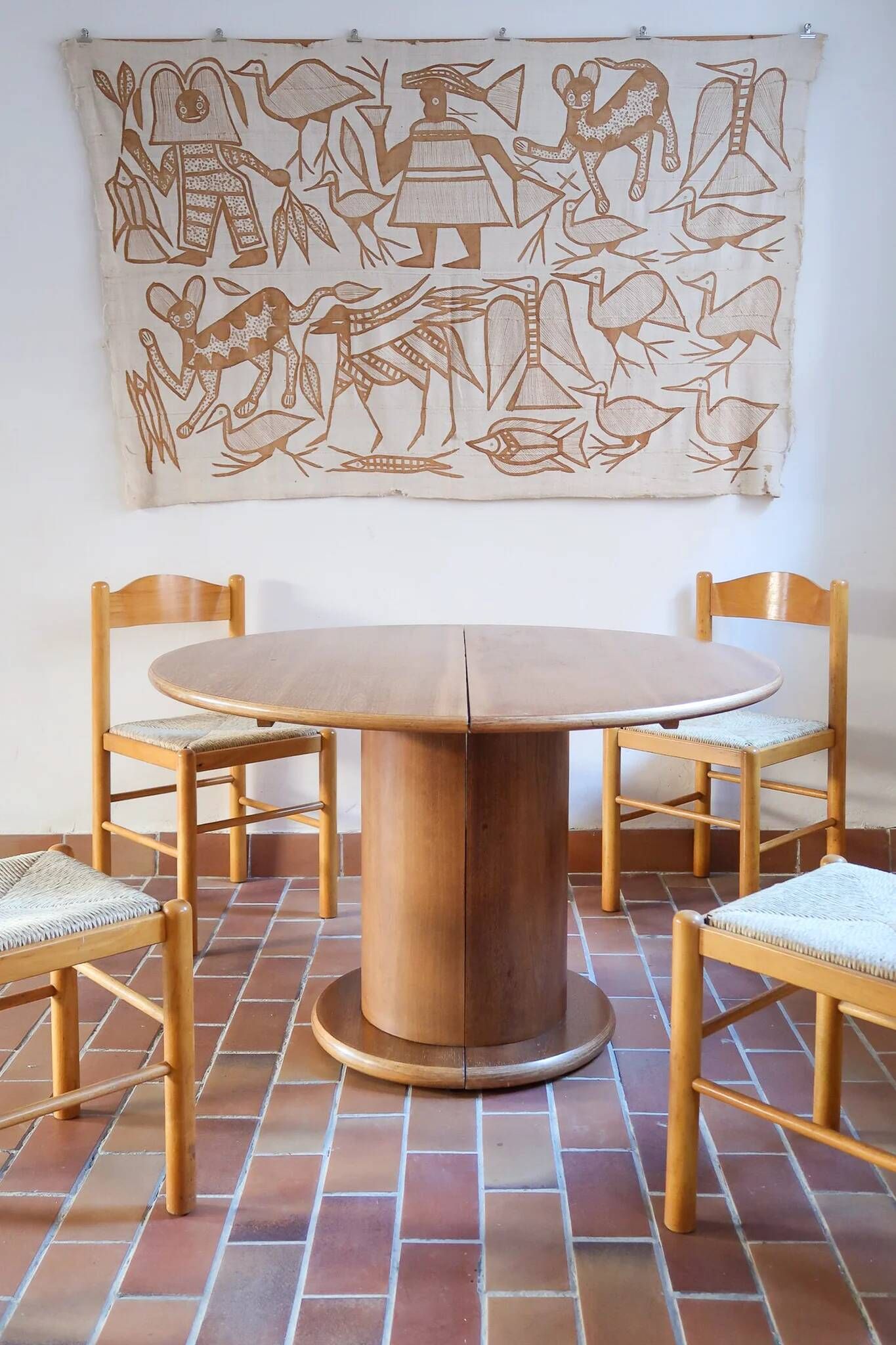 Round table with a central pedestal, light wood, 1990s.