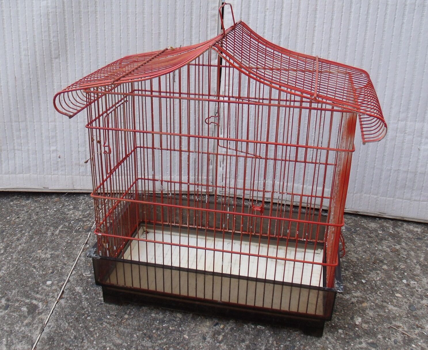 Old red metal birdcage