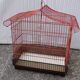 Old red metal birdcage