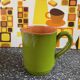 Small two-tone green glazed terracotta jug, height 12 cm.