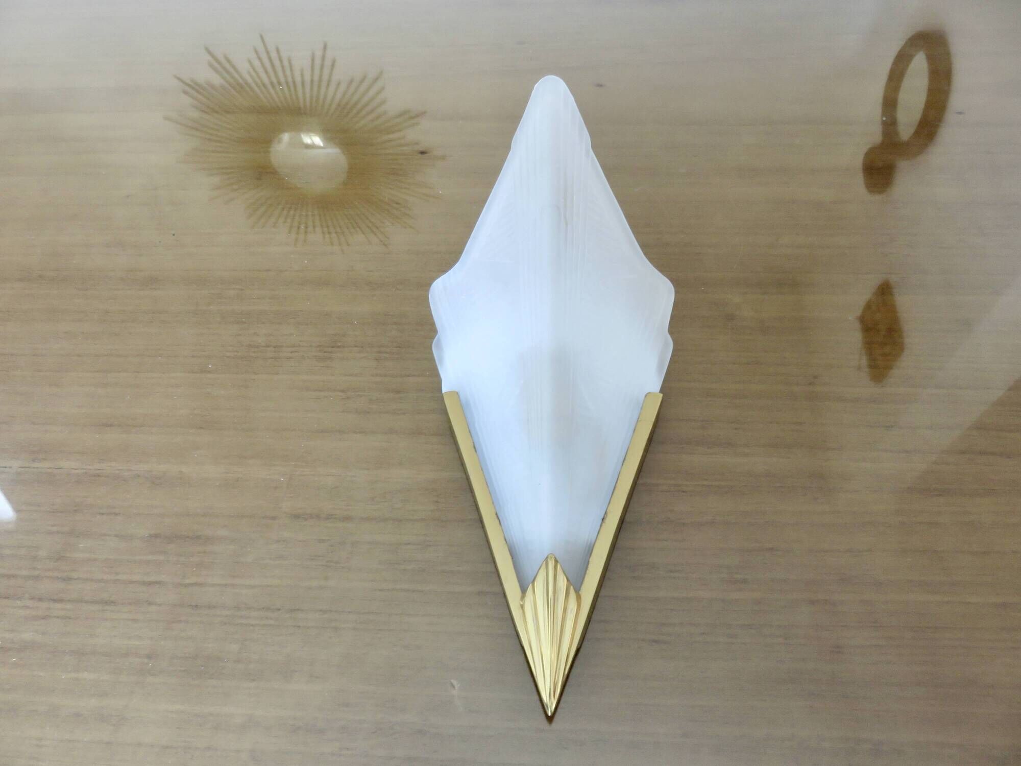 Art Deco wall light in brass and thick frosted glass.