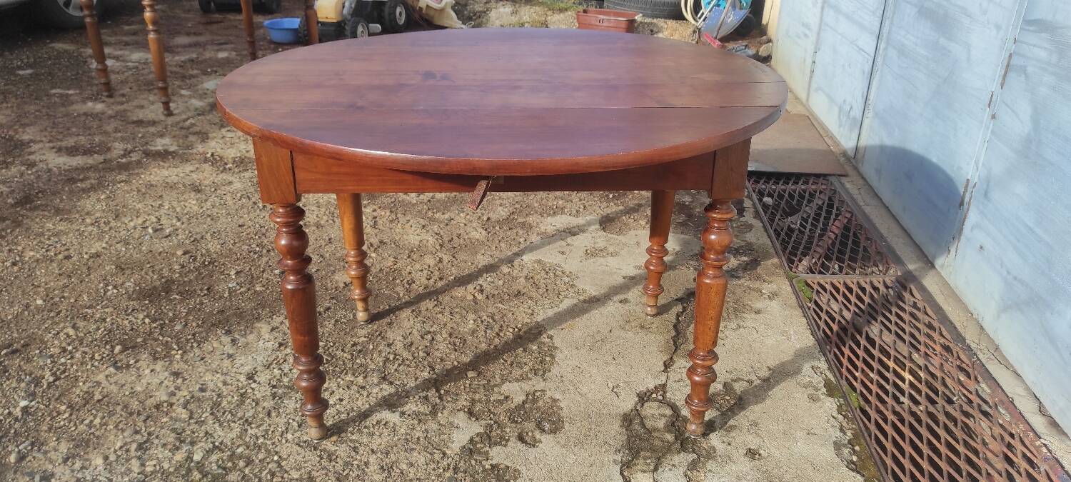 Old extendable round table in fruit wood with folding sides