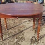 Old extendable round table in fruit wood with folding sides