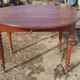 Table ronde ancienne extensible en bois fruitier avec côtés rabattables