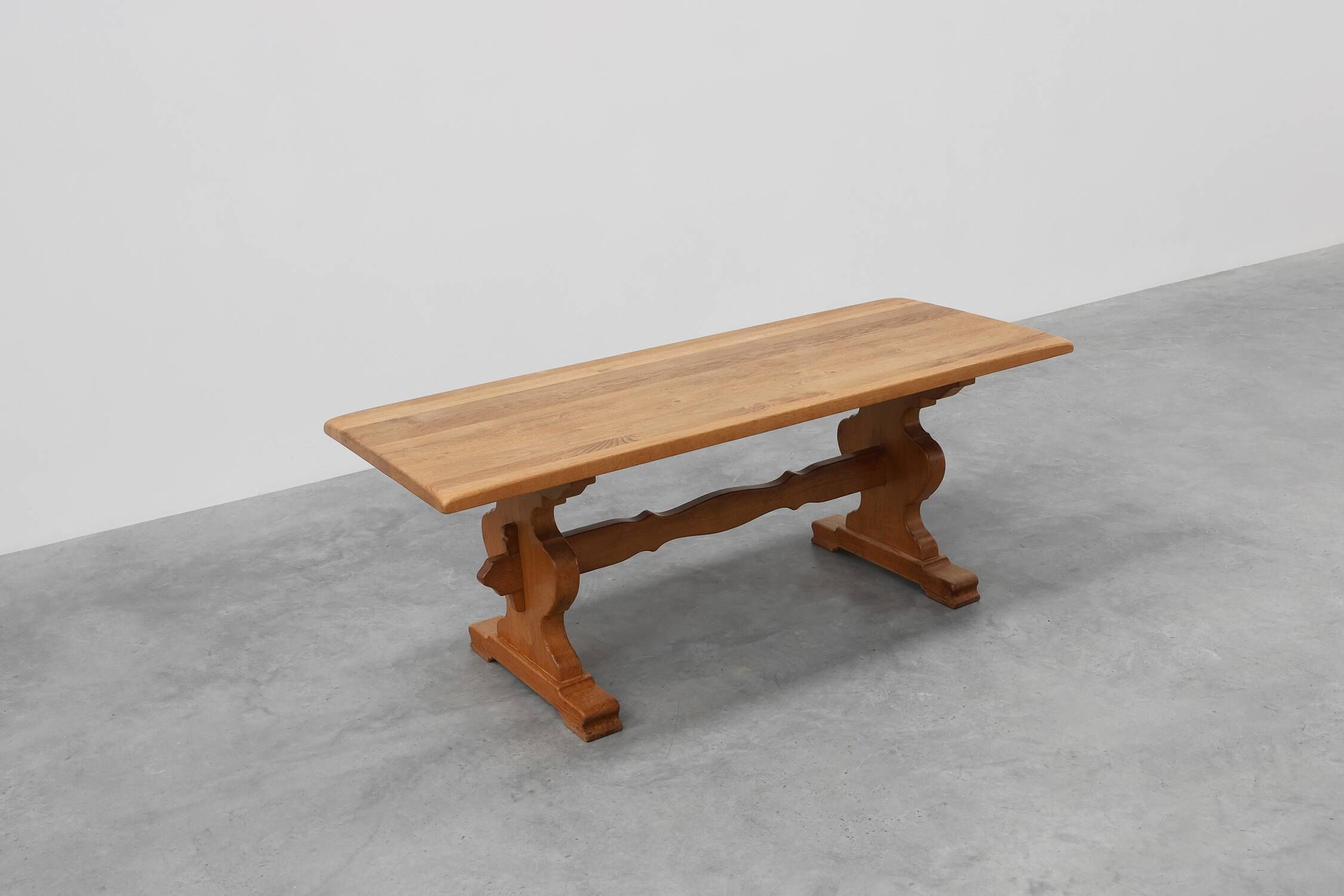 20th Century French oak trestle table with scalloped legs and plank top