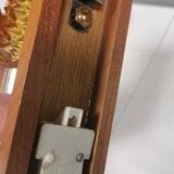 A set of wall lamps in teak wood, with amber colored glass