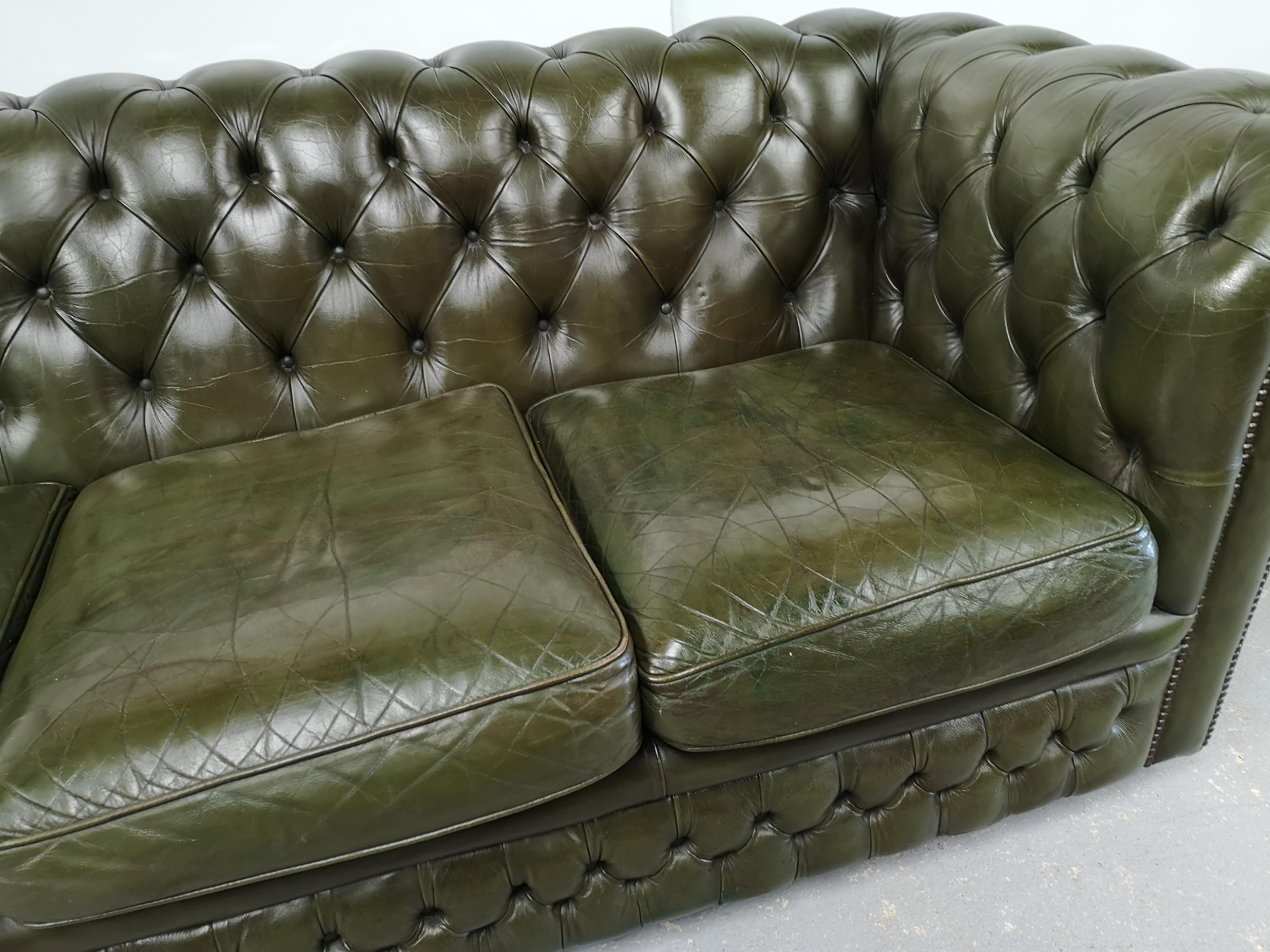 Three-seater green leather Chesterfield sofa