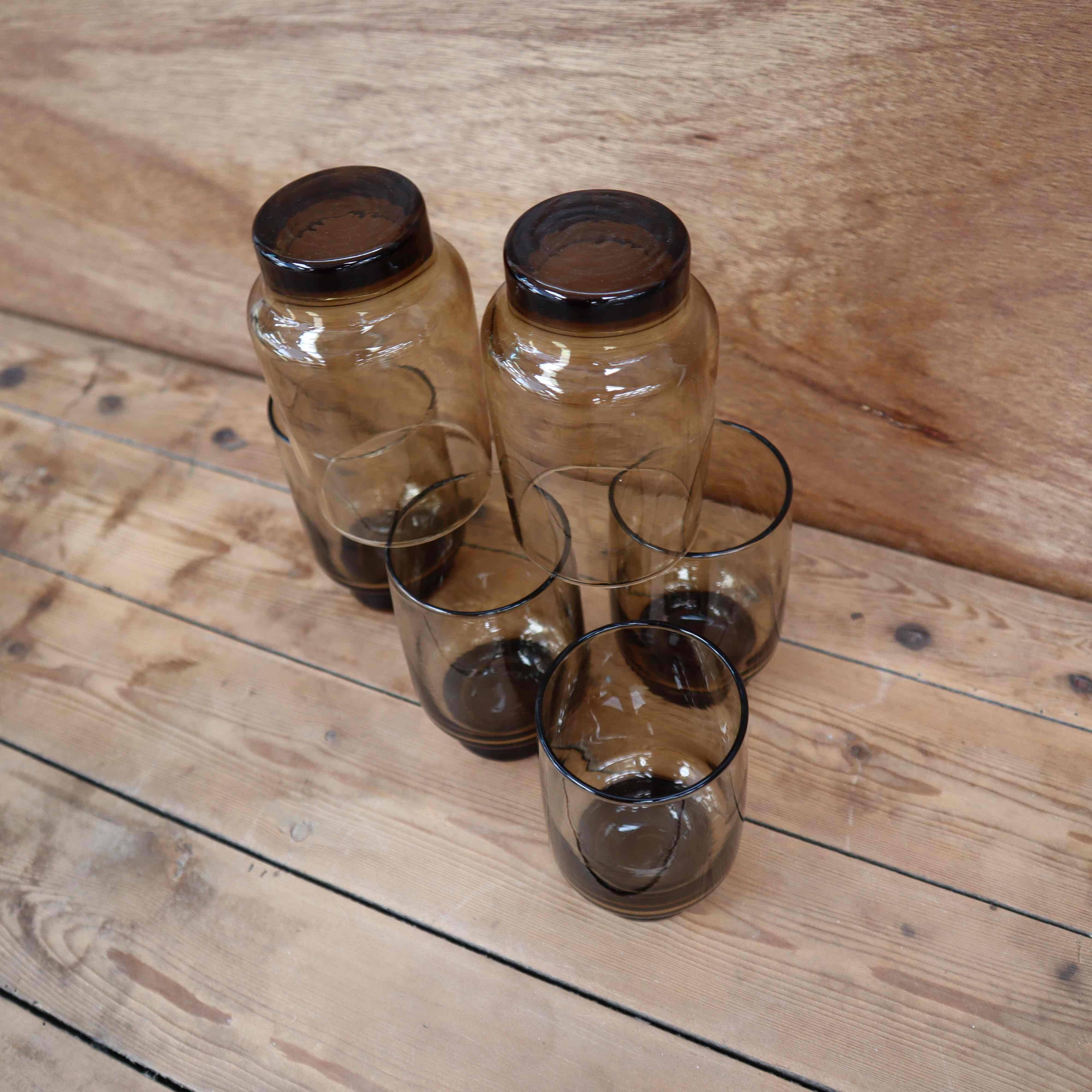 6 Smoked glasses with thick legs from the 70s