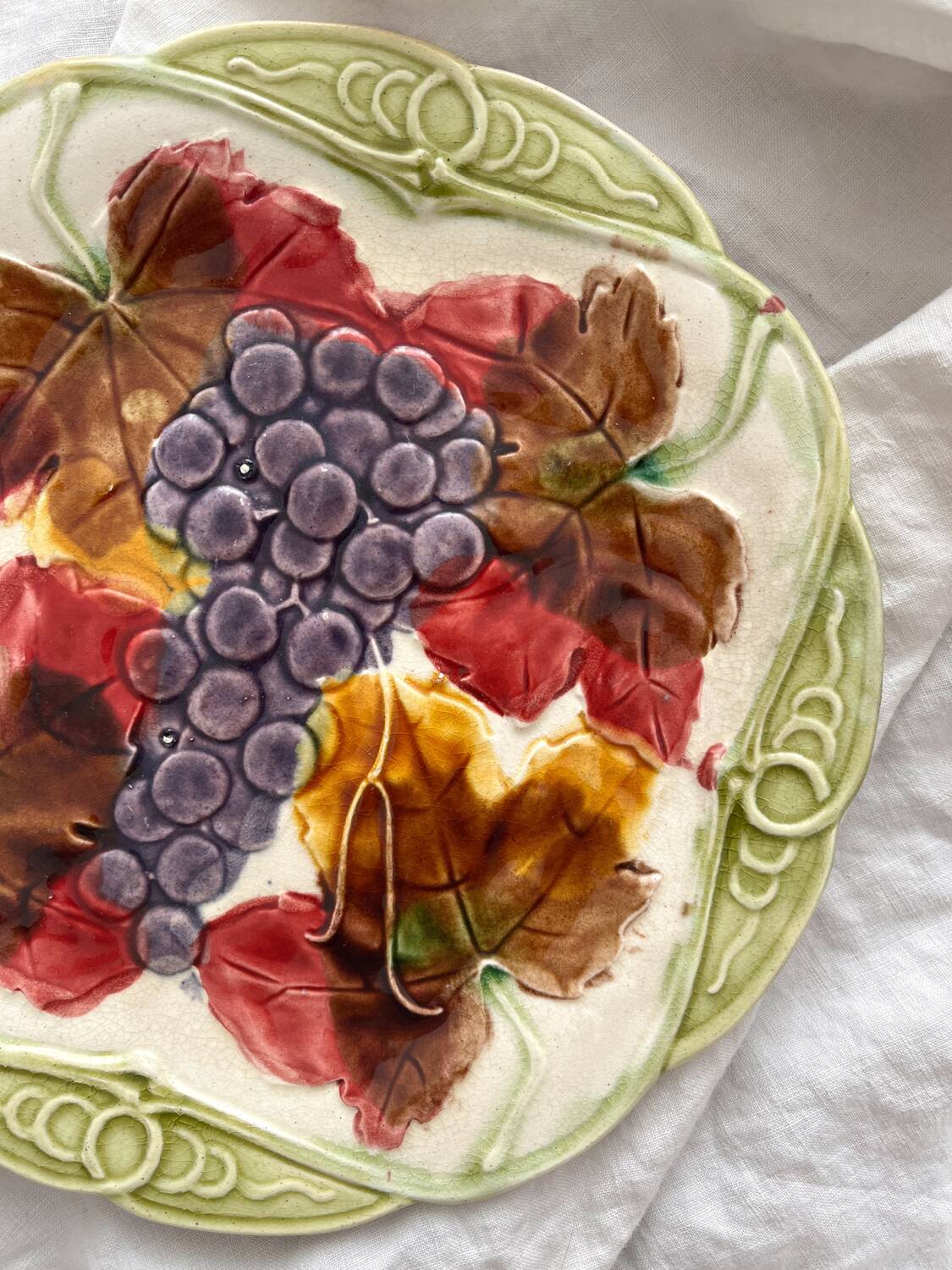 Antique plate in barbotine grapes and vine leaves from Orchies