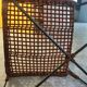 Modernist armchair in woven leather and black metal – 1960s–1970s