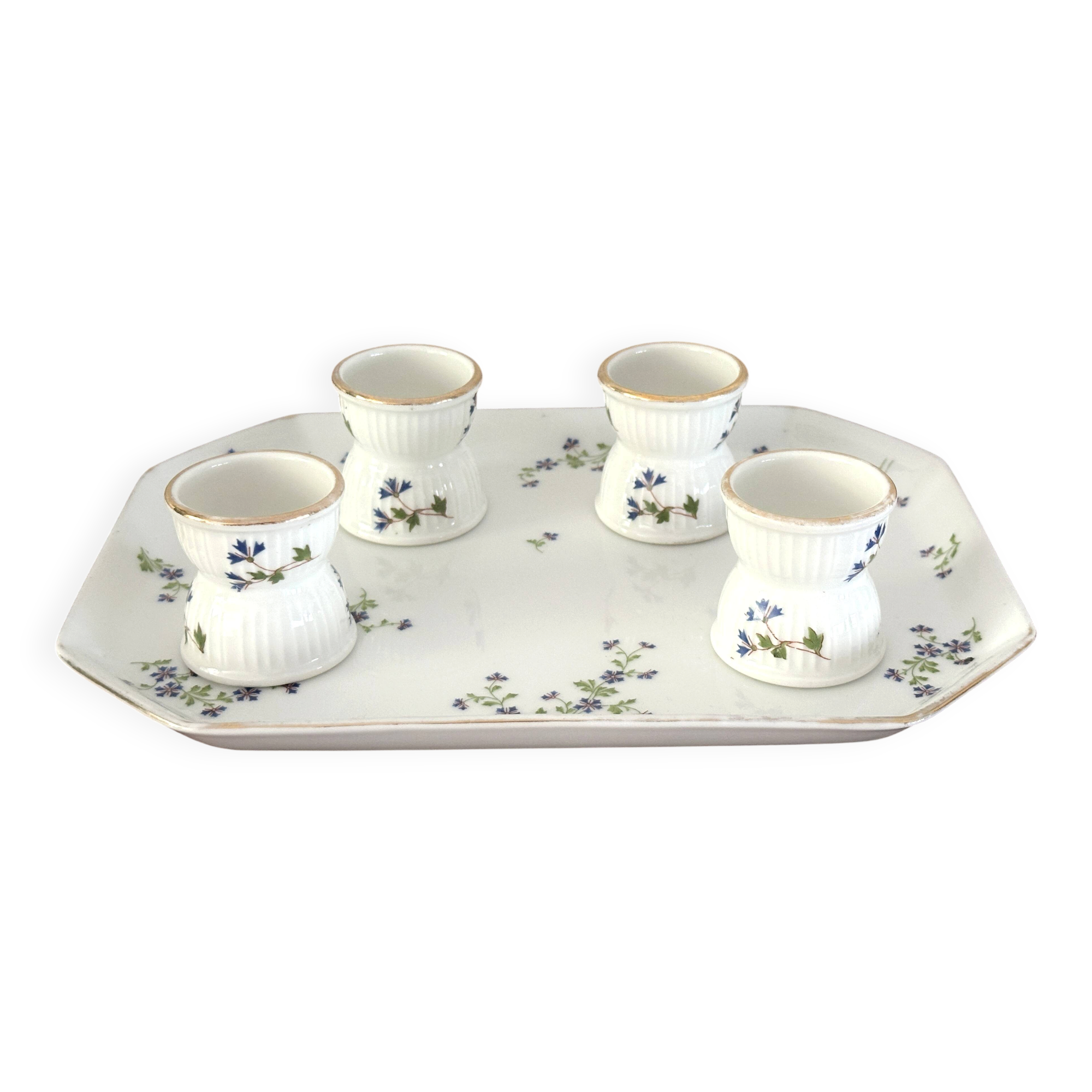 Egg cups on a Limoges porcelain tray by Bernardaud with a barbel decoration.