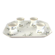 Egg cups on a Limoges porcelain tray by Bernardaud with a barbel decoration.