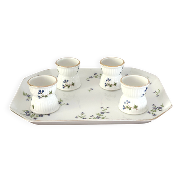 Egg cups on a Limoges porcelain tray by Bernardaud with a barbel decoration.
