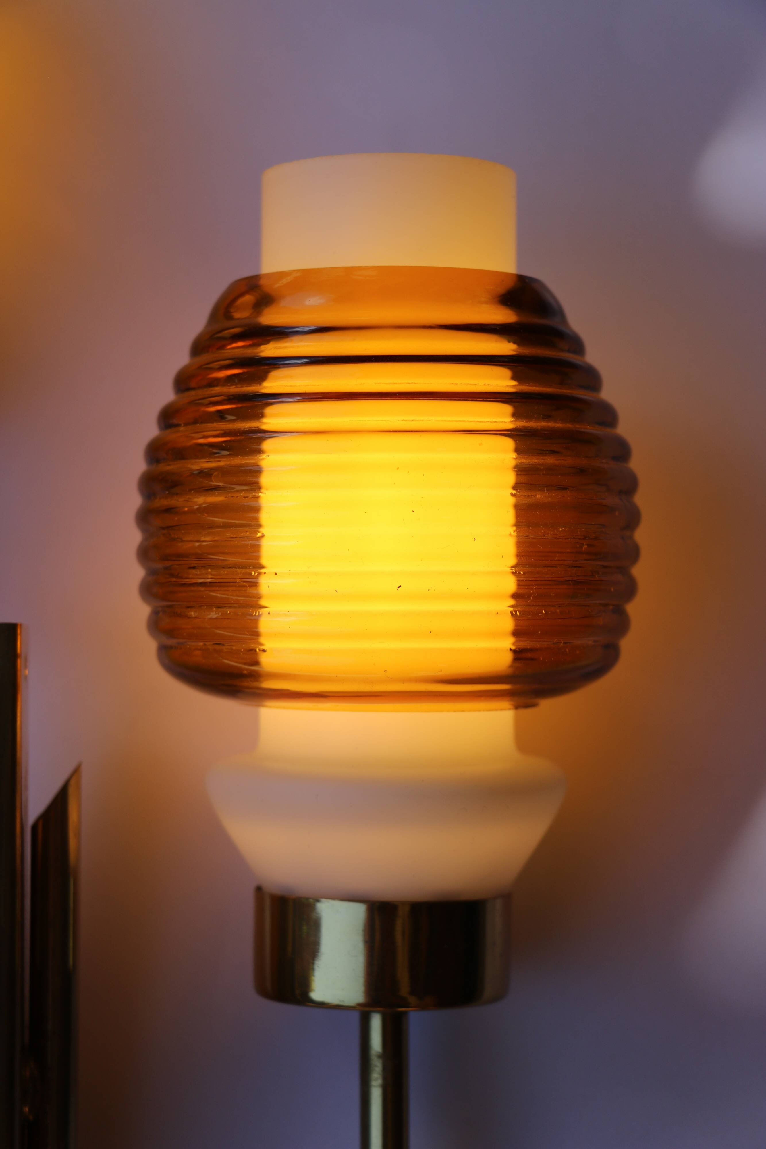 Pair of Scandinavian wall sconces, brass, opal glass and amber glass.