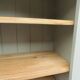 Green-grey library, wooden shelf and shelves in natural wood.