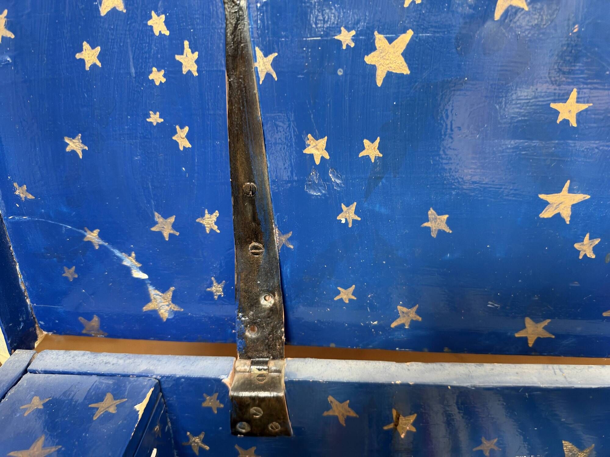 Antique chest hand-painted with a snowy village scene and a starry interior.