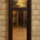Dark wood trumeau with a mirror and landscape painting.
