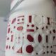 Vintage white opaline ice bucket with red patterns.