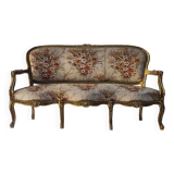 Canapé 3 places en bois sculpté, tapisserie et bois doré. Vers 1900, style Loius XV.