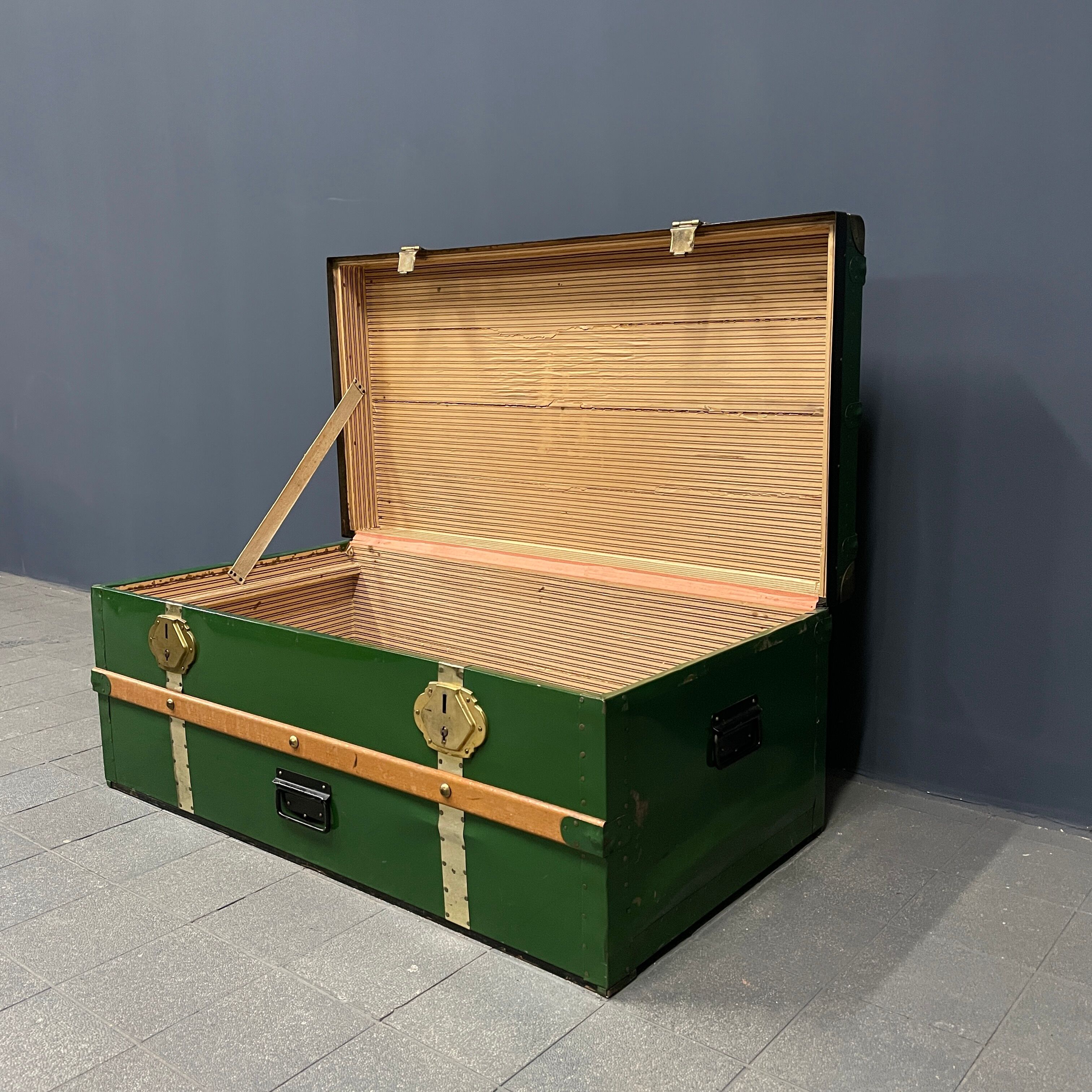 Green metal trunk with wooden sleds