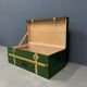 Green metal trunk with wooden sleds