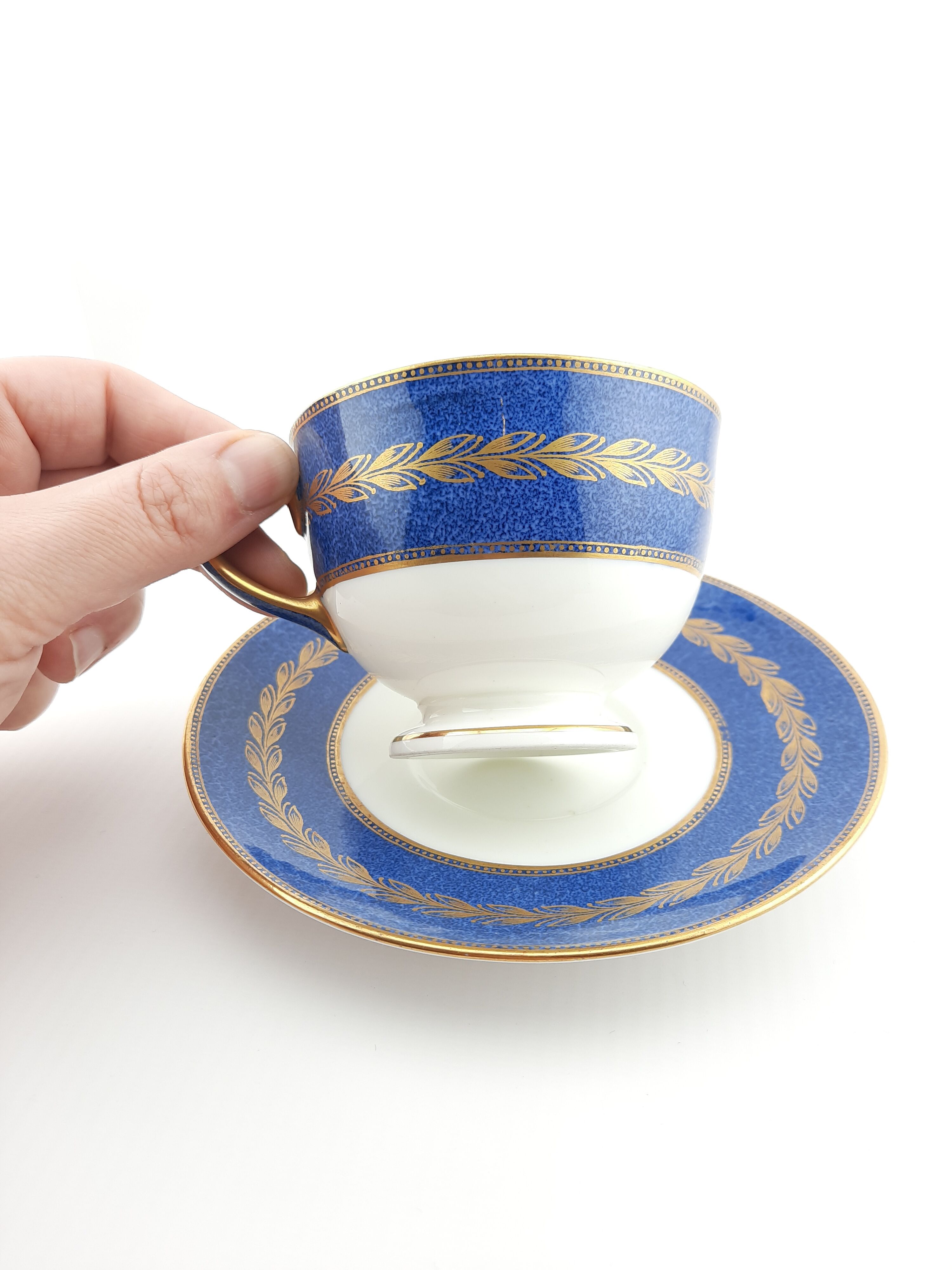 Antique Wedgwood teacup and saucer, bone china. Powder blue and gold English footed cup and saucer,
