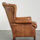 Sheepskin wingback armchair in a light cognac colour in English style