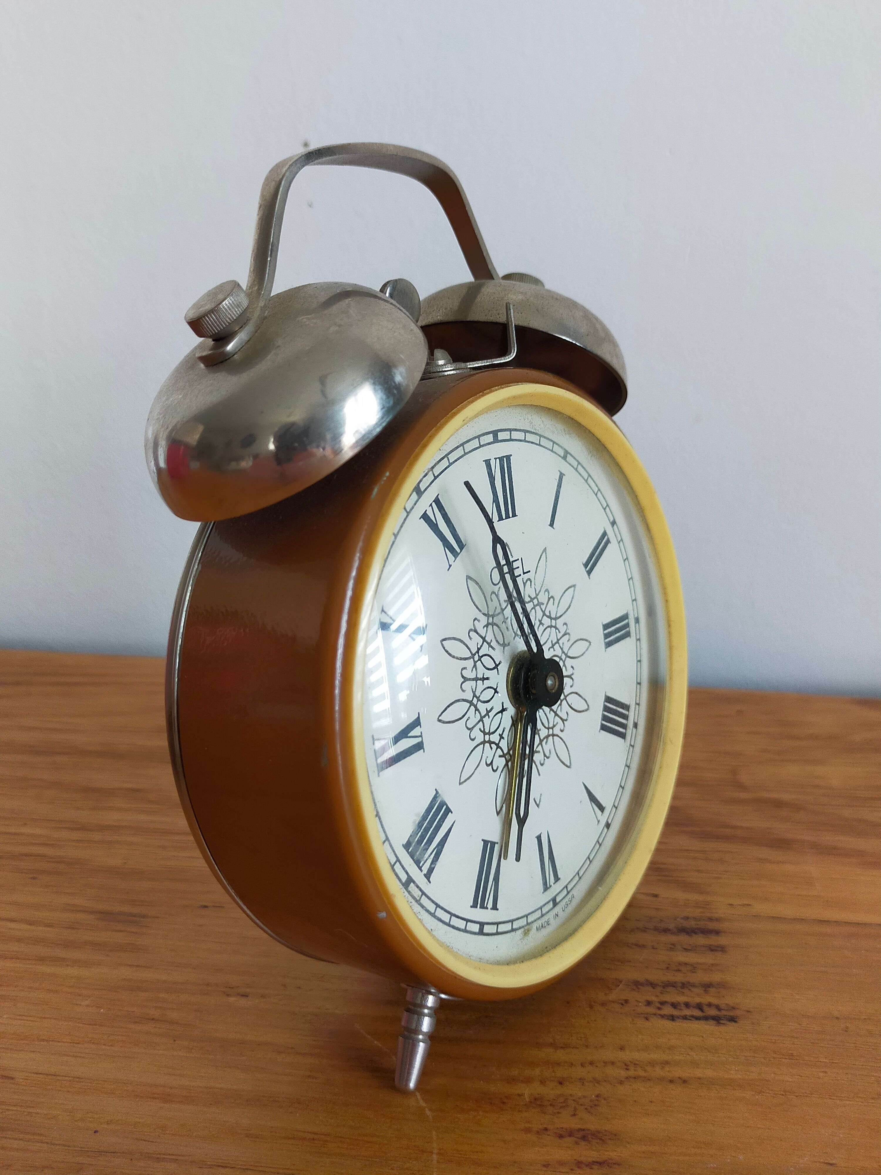 Vintage brown and silver mechanical alarm clock